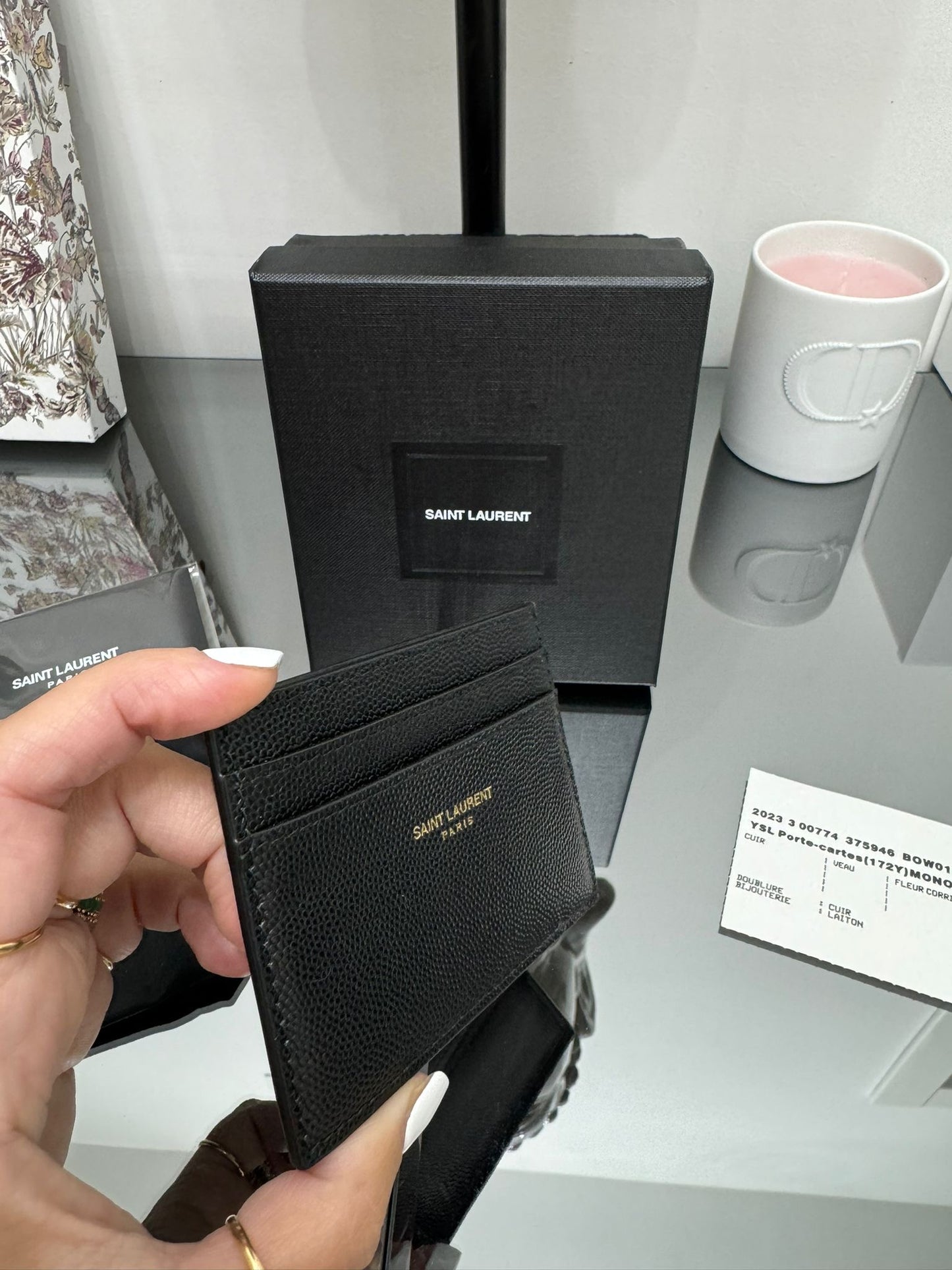 Black leather credit card holder with gold logo