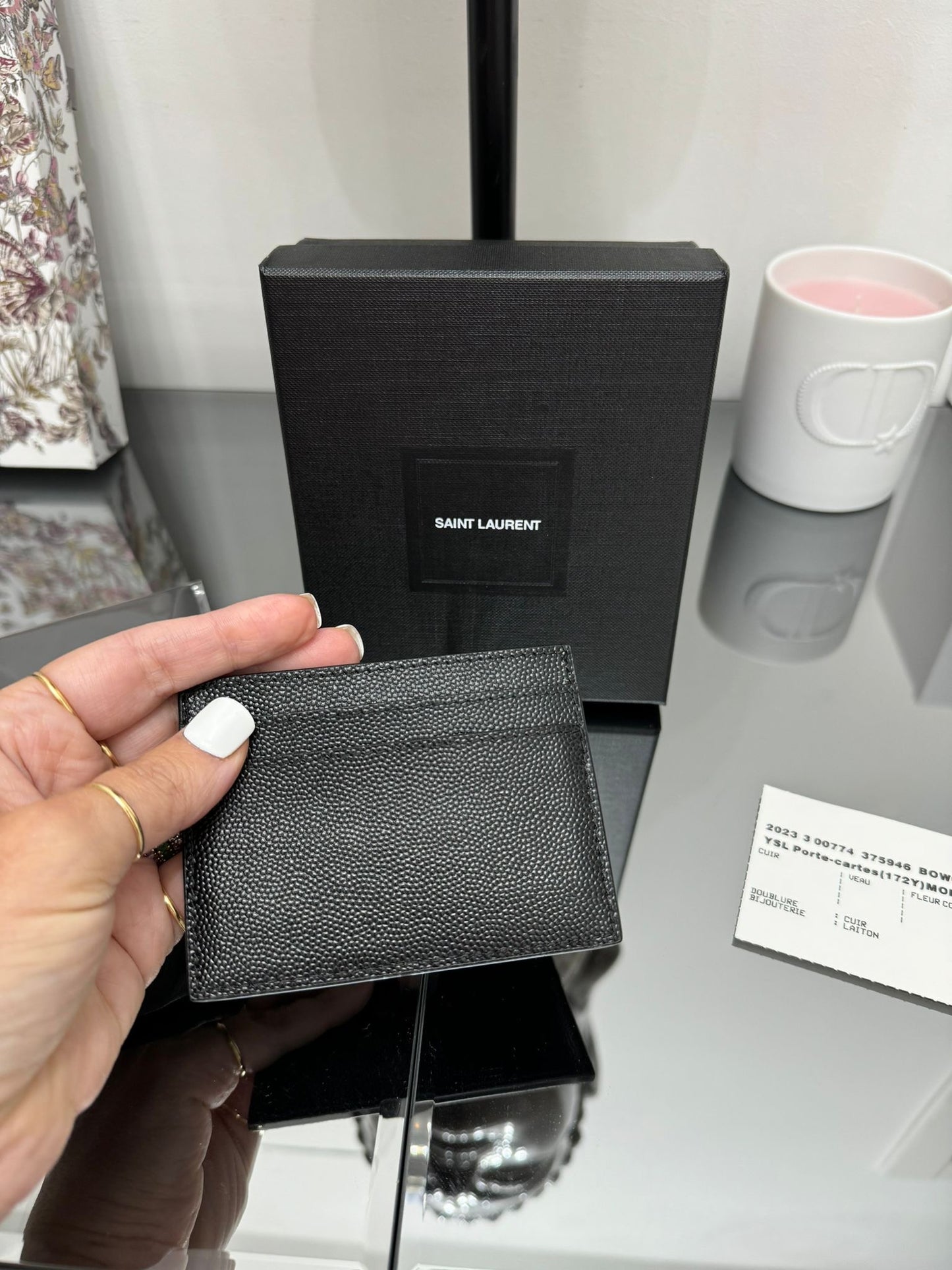 Black leather credit card holder with gold logo